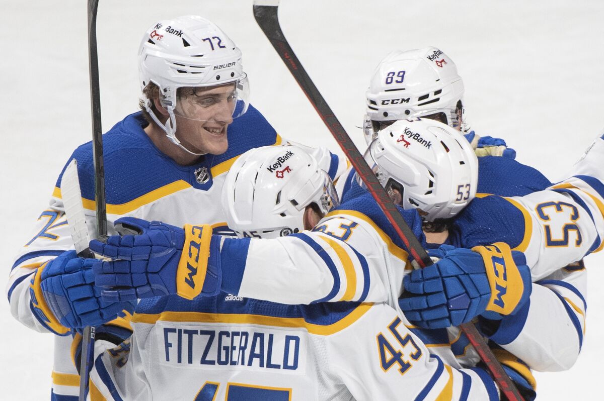 Buffalo Sabres' Jeff Skinner (53) celebrates with teammates after scoring against the Montreal Canadiens during third-period NHL hockey game action in Montreal, Sunday, Feb. 13, 2022. (Graham Hughes/The Canadian Press via AP)