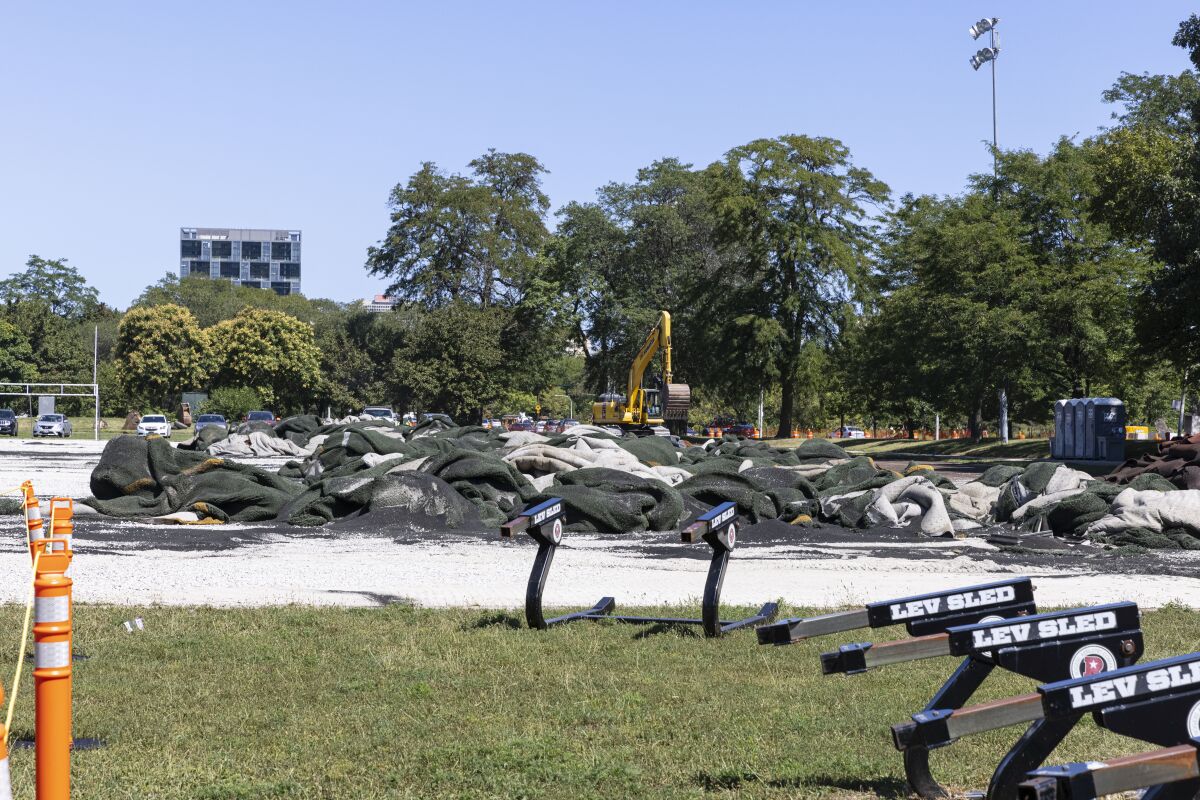Construction crews tear up the turf field and track in Jackson Park starting construction on The Barack Obama Presidential Center in Chicago on Monday, Aug. 16, 2021. (Anthony Vazquez/Chicago Sun-Times via AP)
