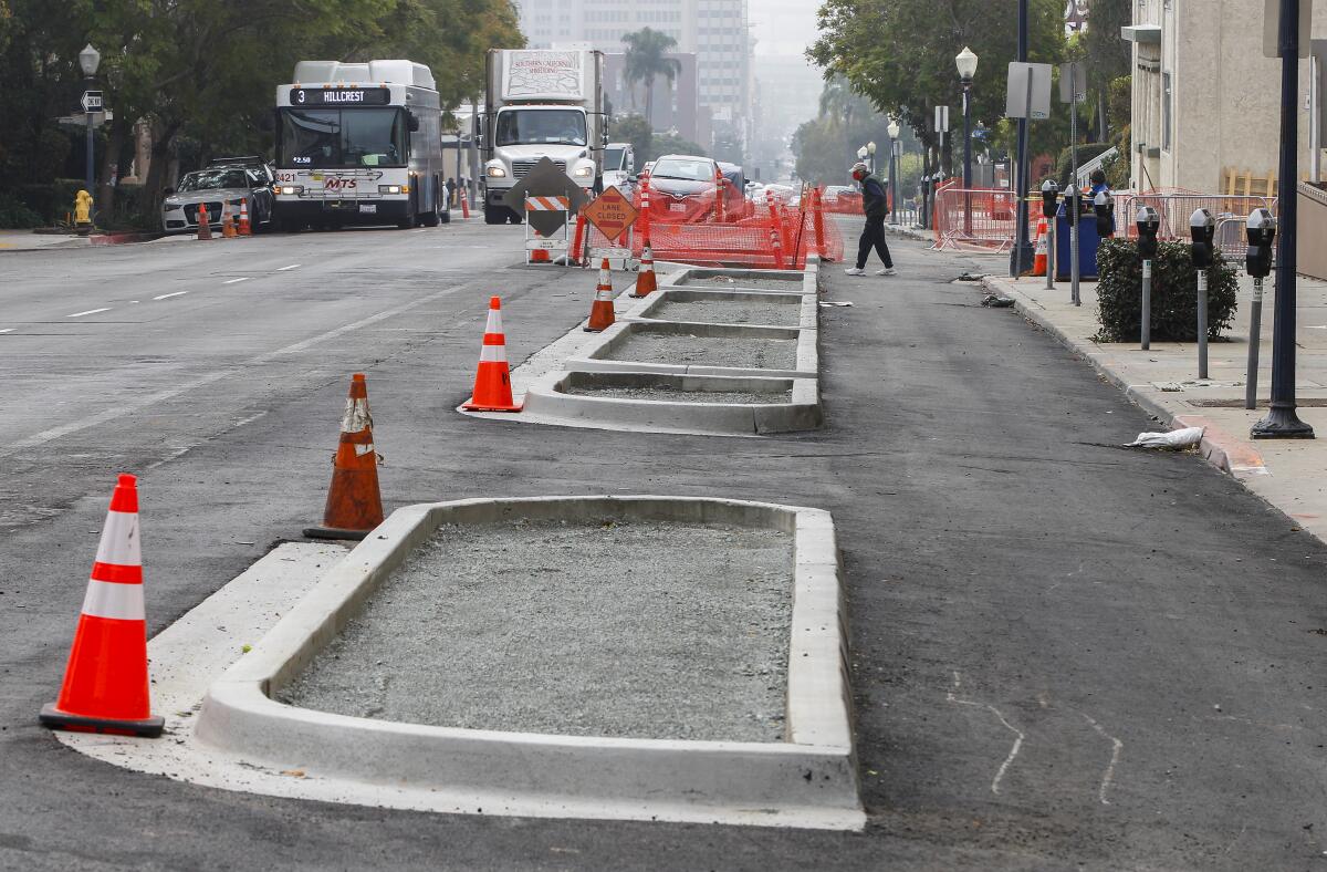 Concrete barriers define a northbound bike lane (right) from traffic (left) along 5th Avenue near Balboa Park.