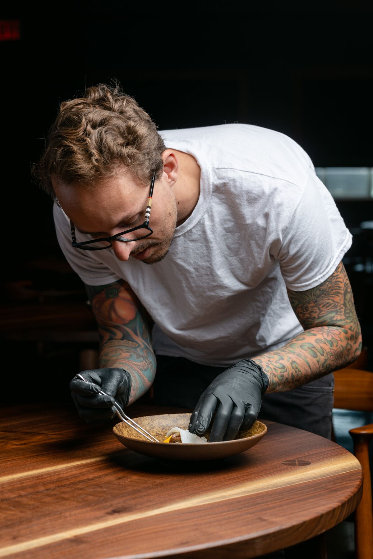 Chef-owner William Eick plates his cuttlefish dish for his new 10-course tasting menu at Matsu restaurant in Oceanside.