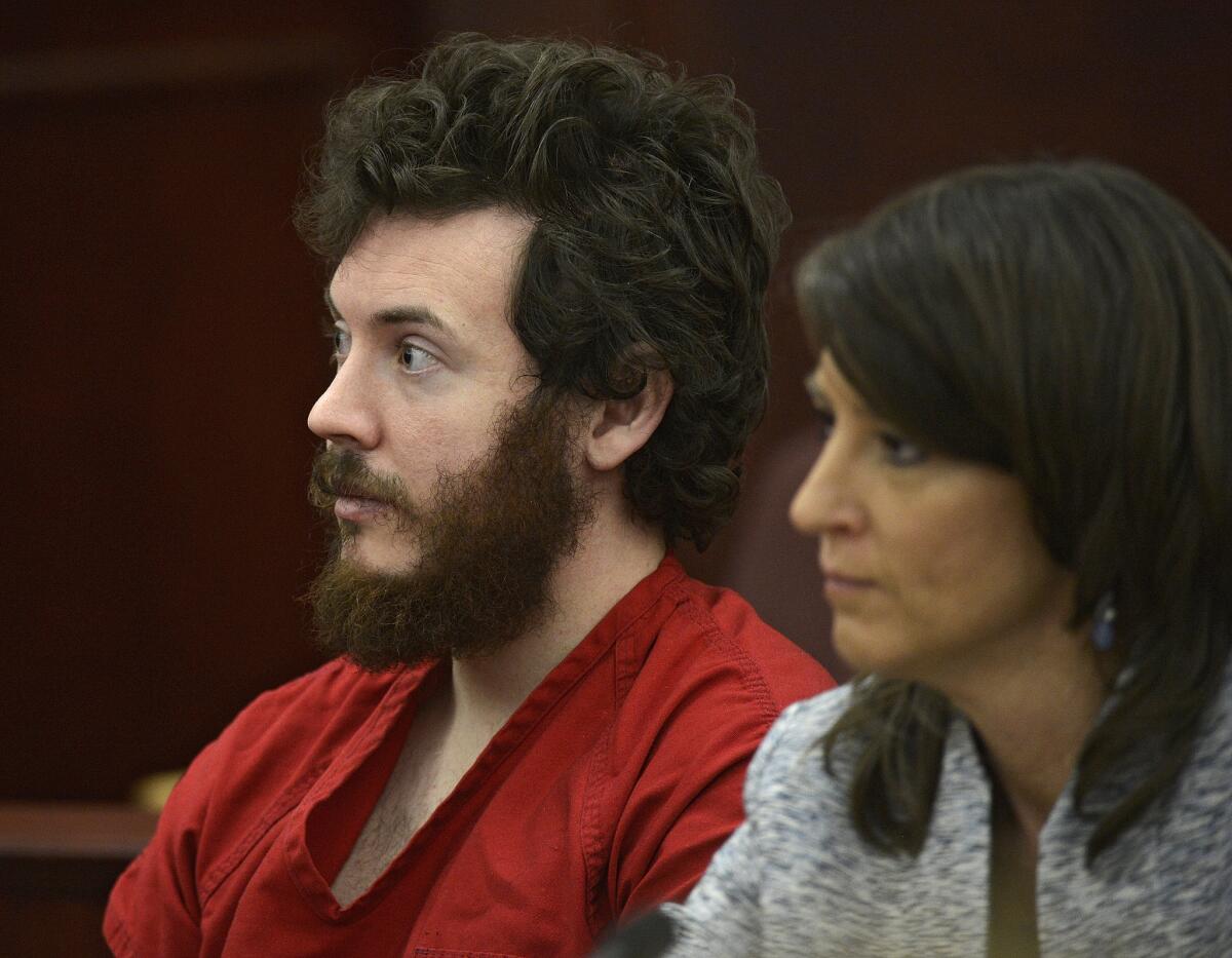 James Holmes, left, and defense attorney Tamara Brady appear in district court in Centennial, Colo. for his arraignment.