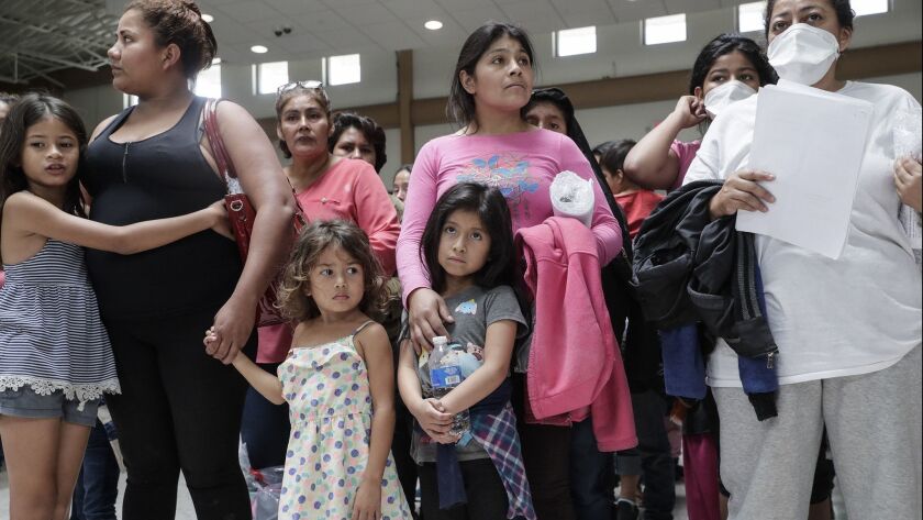 Immigrant families line up to be processed at a bus station in McAllen, Texas, after being released from federal custody.