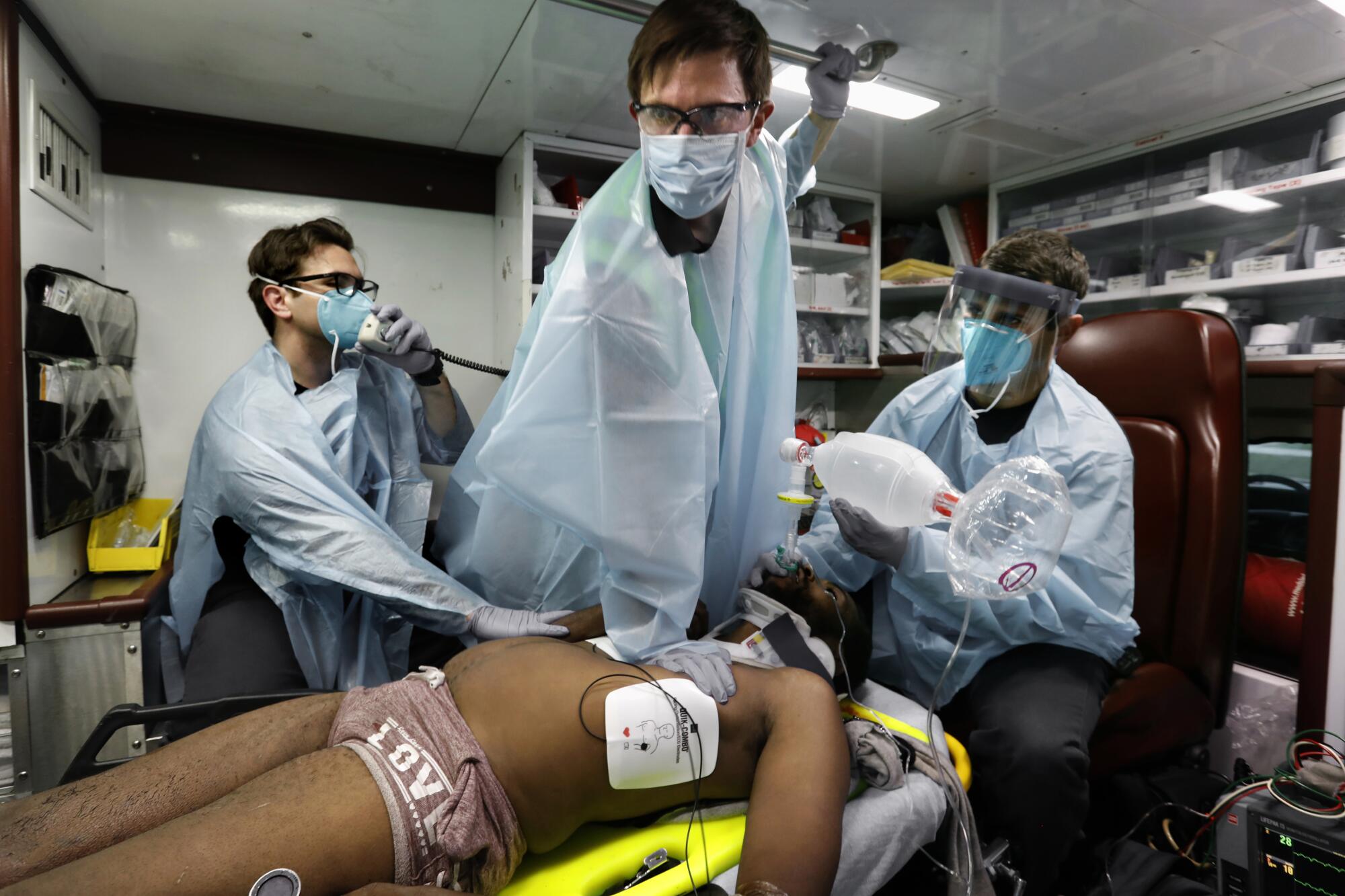 Houston Fire Capt. Daniel Soto, left,  Michael Bravenec and Tom Wolcott  perform CPR on a man.