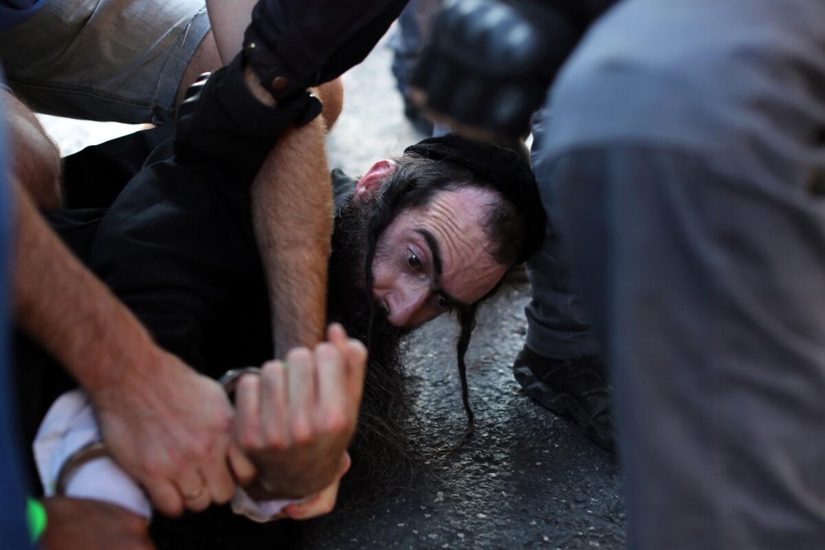 Yishai Shlissel, an ultra-orthodox Jew, is arrested by Israeli police after a stabbing attack on a gay pride march in Jerusalem on July 30.