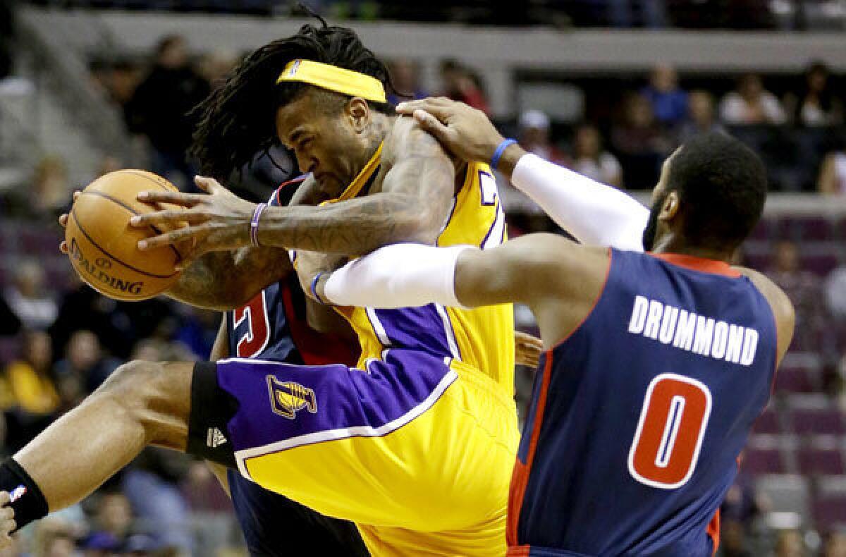 Lakers power forward Jordan Hill is fouled by Pistons center Andre Drummond on an inbounds play in the first quarter Friday evening in Detroit.