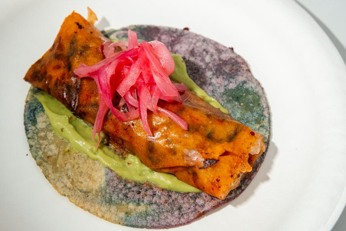 A cheese gobernador taco topped with pickled onion from mariscos truck Simón
