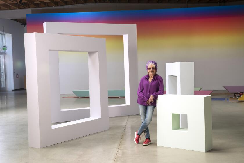 HOLLYWOOD, CA-AUGUST 30, 2019: Artist Judy Chicago is photographed in next to her piece titled, Sunset Squares, acrylic on canvas covered plywood, 1965, remade in 2018, on display at Deitch gallery in Hollywood. Deitch gallery in Hollywood is showing ChicagoÕs early works, produced in L.A. and Fresno between 1965-72. (Mel Melcon/Los Angeles Times)