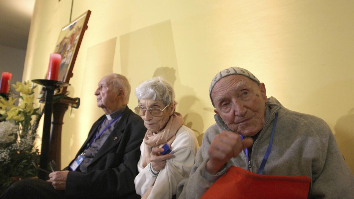 Brother Jean-Pierre Schumacher, right, last survivor of a hostage-taking of monks in 1996, at a spiritual vigil Dec. 7 in the Roman Catholic Cathedral of St Mary in Oran, Algeria.