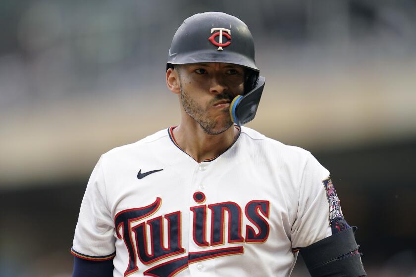 Minnesota Twins' Carlos Correa reacts while batting during the third inning of a baseball game agains the San Francisco Giants Sunday, Aug. 28, 2022, in Minneapolis. (AP Photo/Abbie Parr)