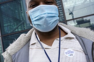 Flight attendant Rick Easley II wears a vaccination sticker after getting a COVID-19 shot in New York City.