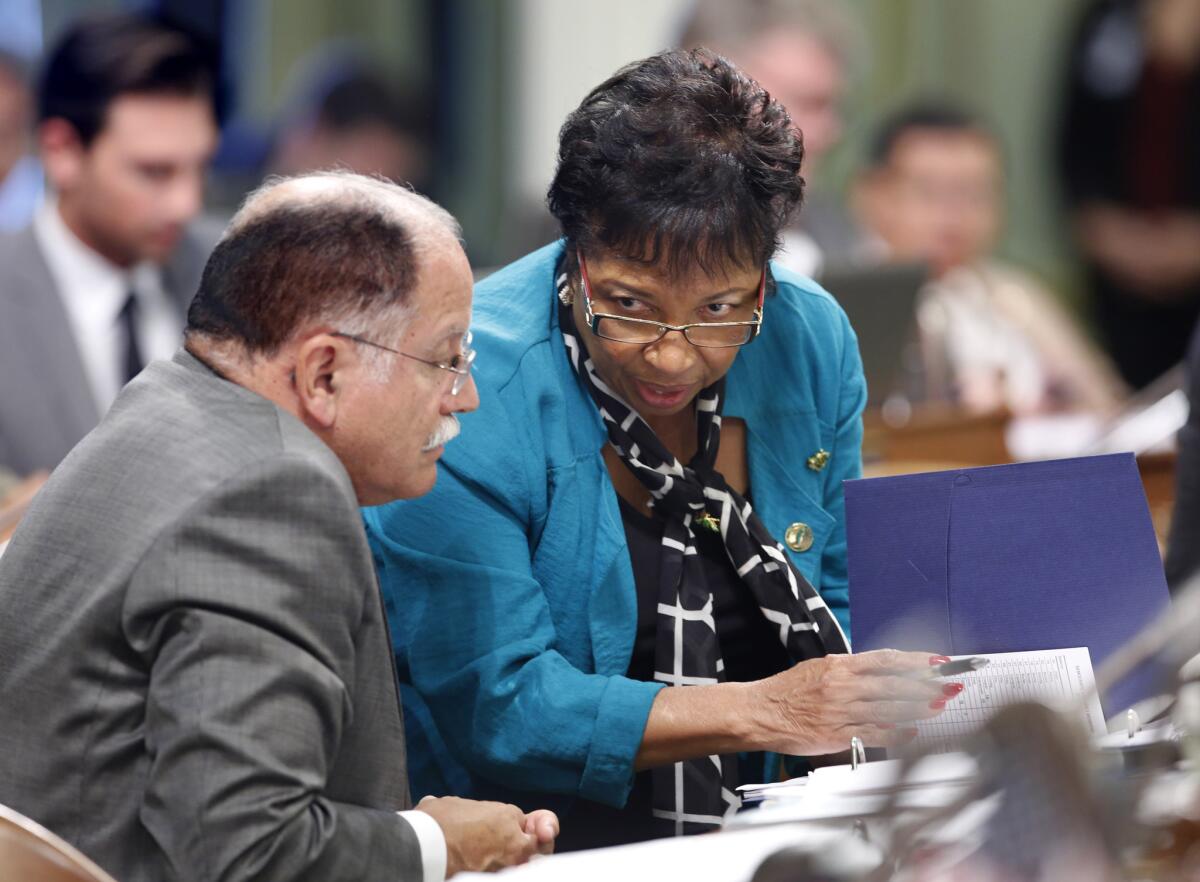 Assemblywoman Cheryl Brown, D-San Bernardino, talks with Assemblyman Jose Medina, D-Riverside on Feb. 24, 2016. Brown faces an unexpected challenge from the left this year as political fallout for her moderate votes.