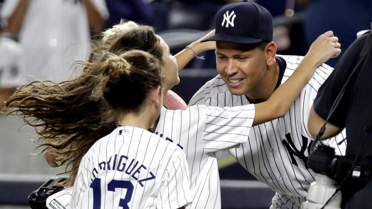 Alex Rodriguez is greeted by his daughters, Ella and Natasha, after his final game with the Yankees on Friday night.
