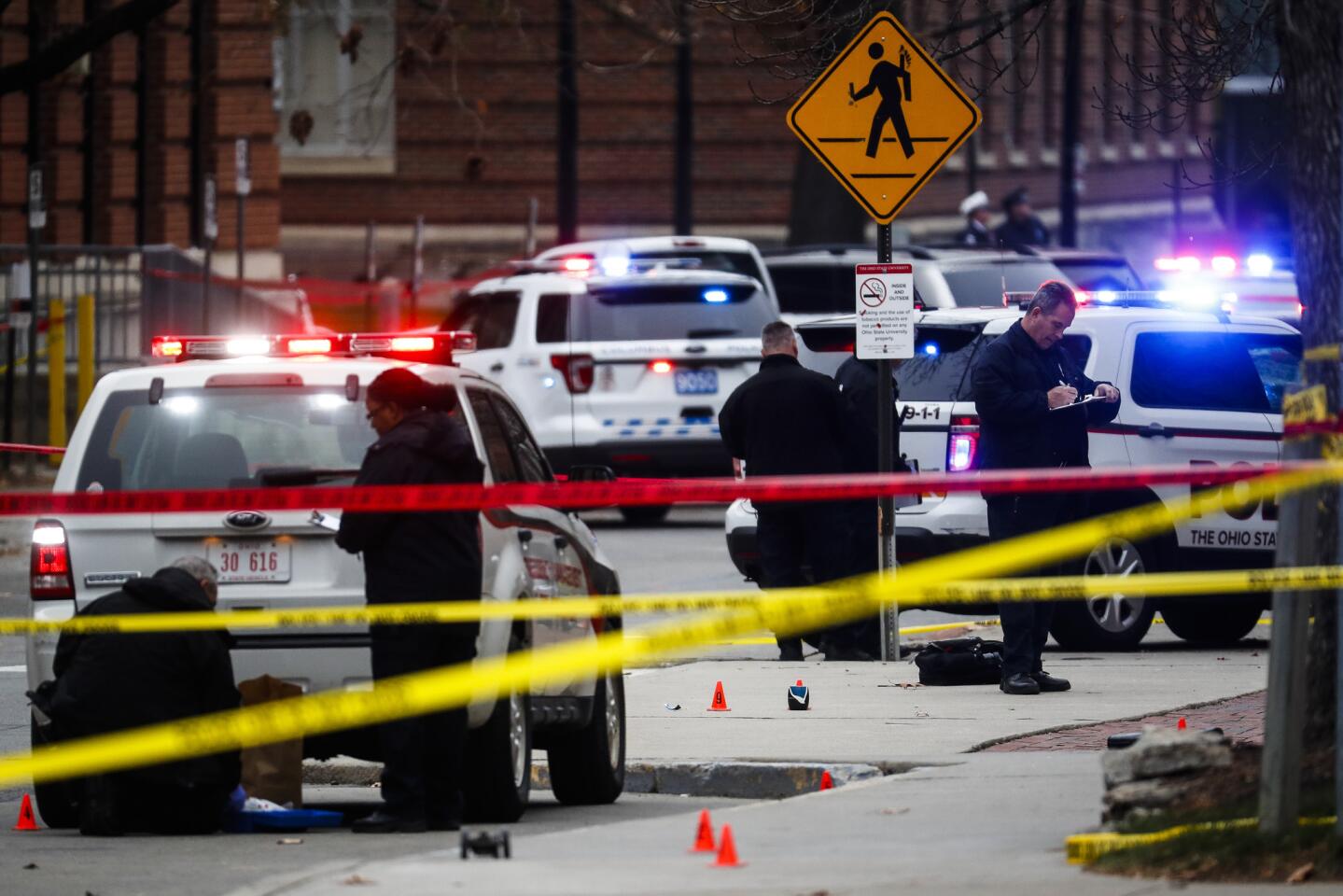 Crime scene investigators collect evidence from the pavement as police respond to an attack on campus at Ohio State University on Nov. 28, 2016, in Columbus, Ohio.