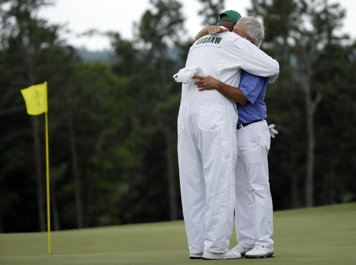 Ben Crenshaw hugs his longtime caddie Carl Jackson on the 18th hole after what Crenshaw says will be his last round at the Masters.