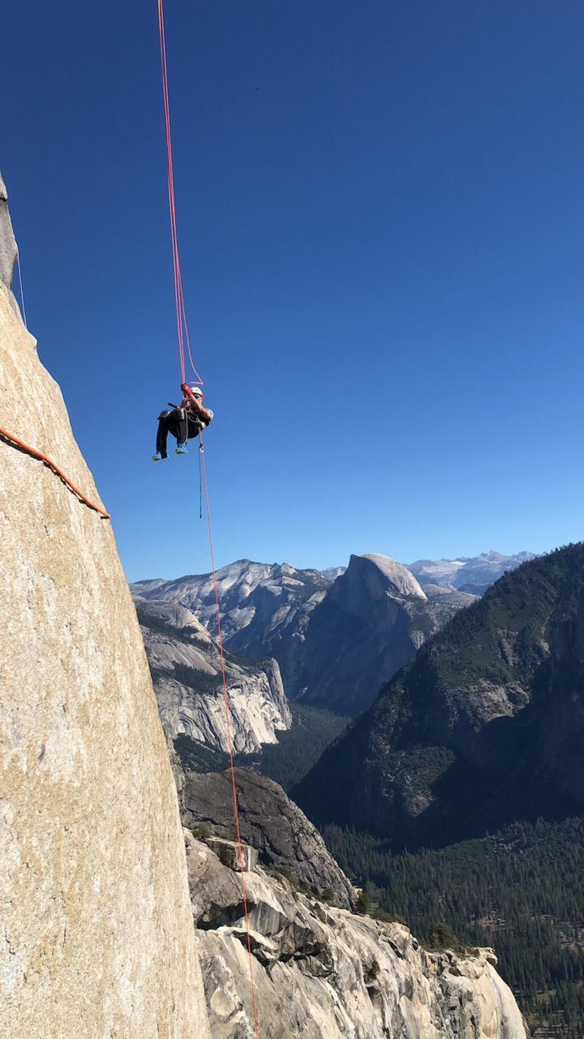 Zuko Carrasco dangles from a climbing rope on El Capitan. 