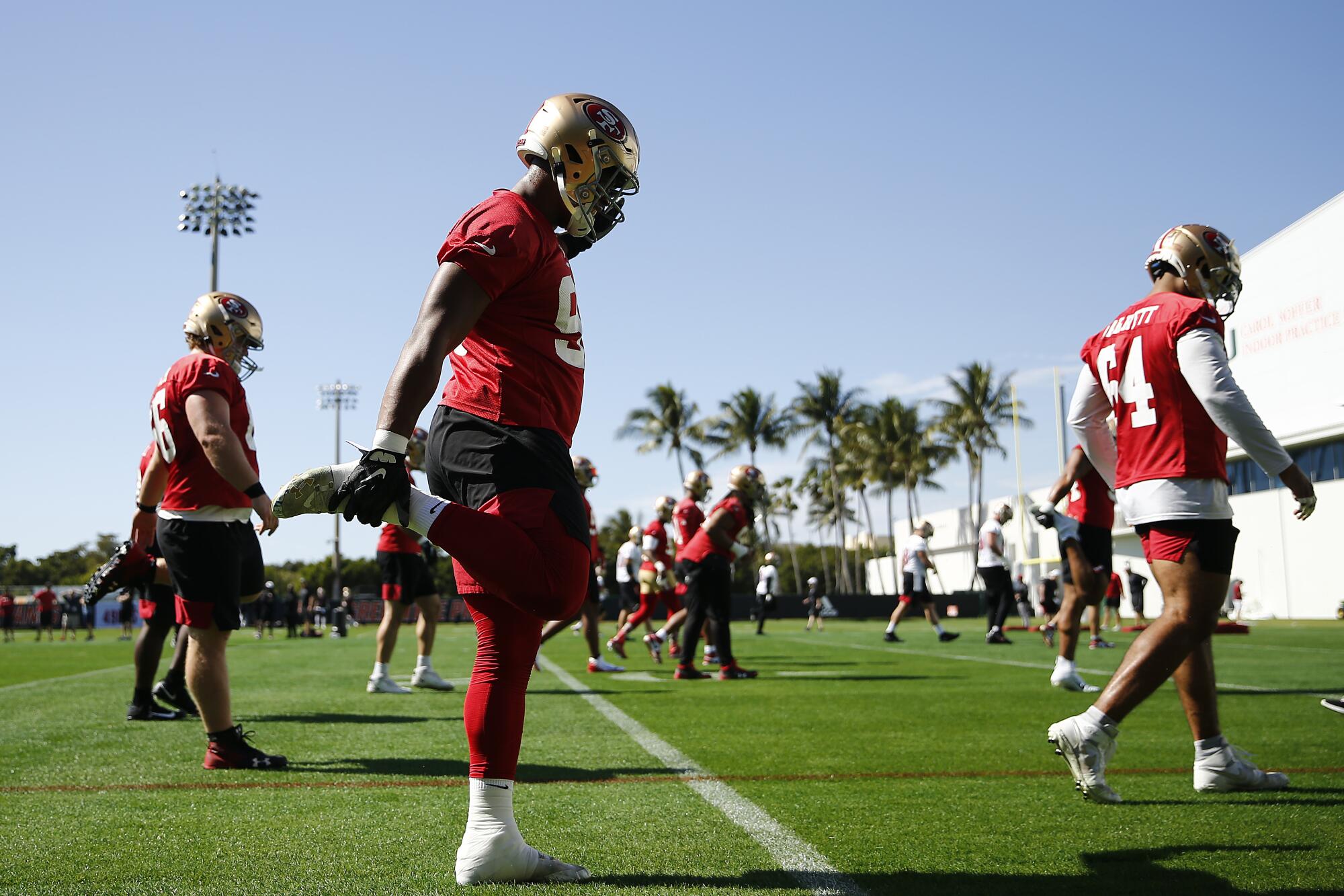 The San Francisco 49ers stretch during practice at the University of Miami on Thursday.