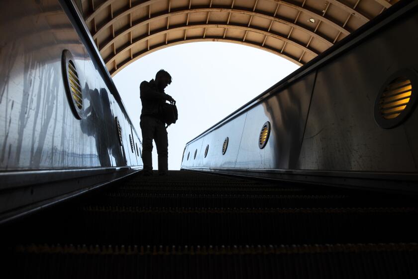 LOS ANGELES, CA - MAY 20: A man rides an escalator down into the METRO Red Line tunnel at North Hollywood Station on Thursday, May 20, 2021 in Los Angeles, CA. (Brian van der Brug / {credit