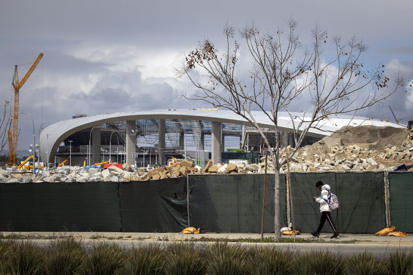 INGLEWOOD, CALIF. -- THURSDAY, MARCH 19, 2020: Construction workers work on the SoFi Stadium in Inglewood where the Rams and Chargers will be playing Thursday, March 19, 2020. (Allen J. Schaben / Los Angeles Times)