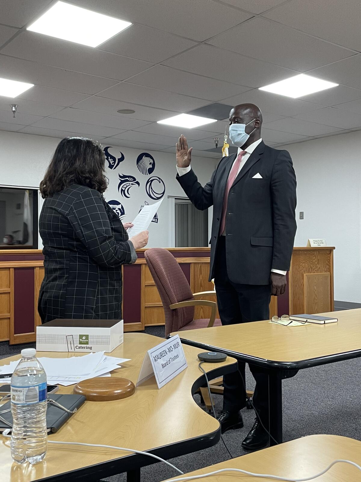 SDUHSD President Mo Muir gives the oath of office to new trustee Ty Humes.