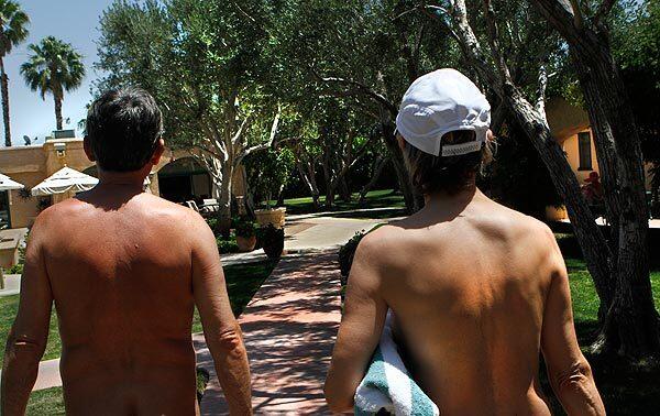 A couple walks to one of the three pools at the Desert Sun nudist resort in Palm Springs. Resort owners Elizabeth and John Young banned children as of April 2011.