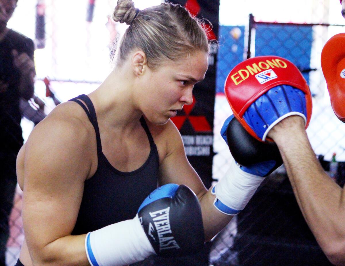UFC figher Ronda Rousey spars with her trainer Edmond Tarverdyan at the Glendale Fighting Club on Monday, June 23, 2014.
