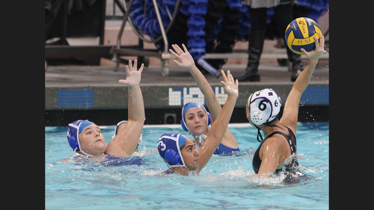 Optimistic, Hoover's Anahit Mirzoyan rises to shoot against three Burbank defenders in a Pacific League girls' water polo match at Burbank High School on Tuesday, January 10, 2017. Burbank won the match.