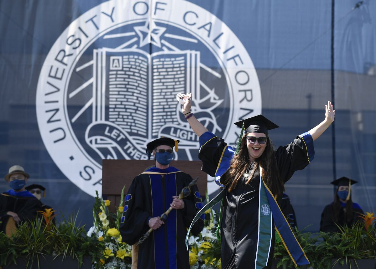 UC San Diego graduate Lisa Nicole Flores Chandler celebrates onstage during the Muir College commencement ceremony June 12.