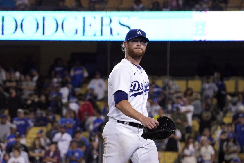 Dodgers relief pitcher Craig Kimbrel leaves the field after being taken out of play.