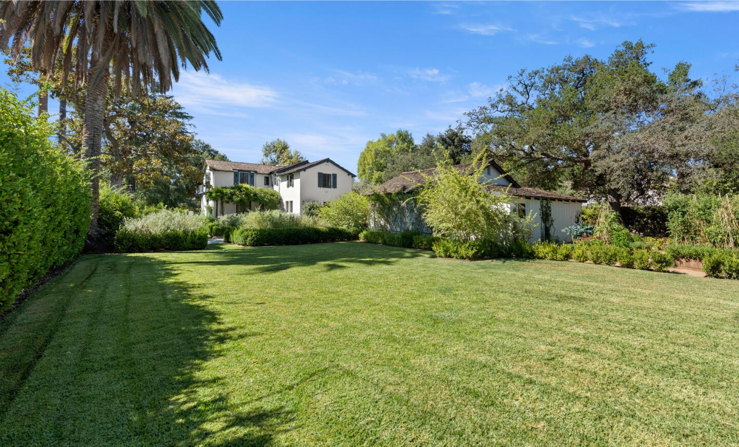 The expansive lawn in front of the two-story home.