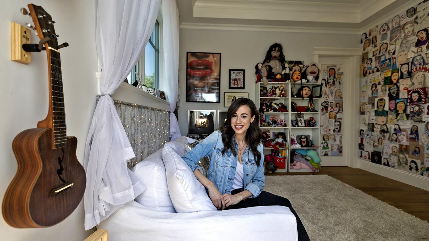 Ballinger has designated half of her home office as the space for her alter ego, Miranda Sings. The area serves as the backdrop for her YouTube videos and features an entire wall and bookshelf adorned with eccentric fan art and gifts.