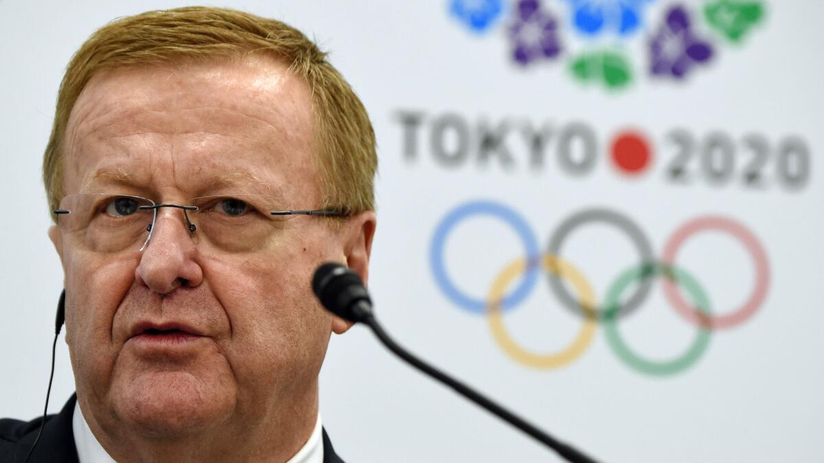 John Coates, International Olympic Committee vice president, answers questions during a news conference in Tokyo on Wednesday.