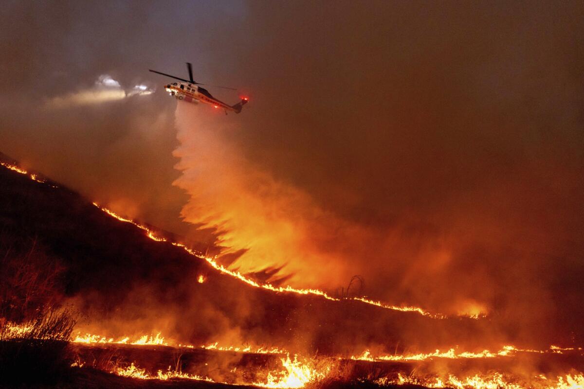 A helicopter drops water