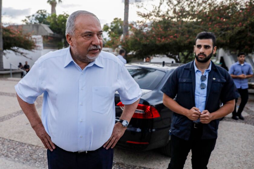Israeli politician Avigdor Lieberman, left, leader of the nationalist Yisrael Beiteinu party, arrives at Kibbutz Nahal Oz in southern Israel on Sept. 12, 2019, while campaigning for the Sept. 17 vote.