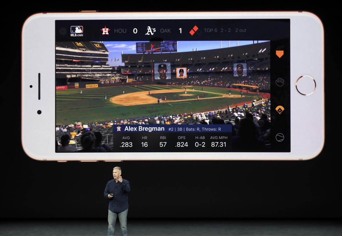 Phil Schiller, Apple's senior vice president of worldwide marketing, shows an augmented reality feature.