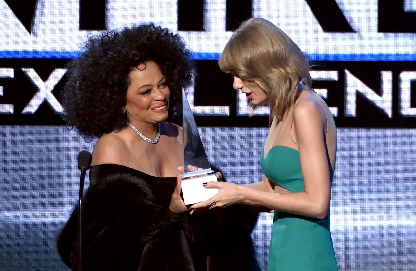 Diana Ross, left, presents the Dick Clark Award for Excellence to Taylor Swift.