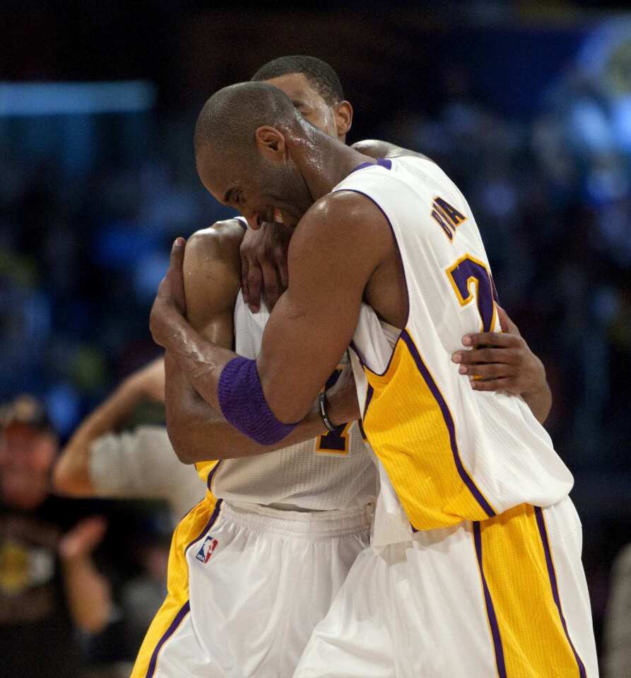 Lakers guards Kobe Bryant and Ramon Sessions embrace in the closing seconds of a 120-112 victory over the Warriors on Sunday night at Staples Center.