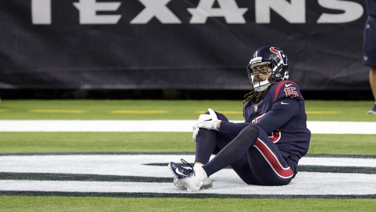 Houston Texans wide receiver Will Fuller holds his knee during the second half of Thursday's game against the Miami Dolphins.