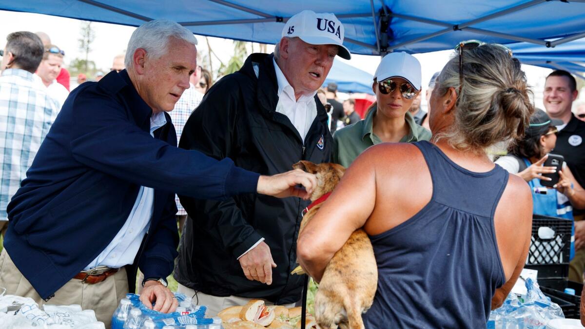 From left, Vice President Mike Pence, President Trump and First Lady Melania Trump greet Florida residents impacted by Hurricane Irma in Naples on Thursday, Sept. 14, 2017.