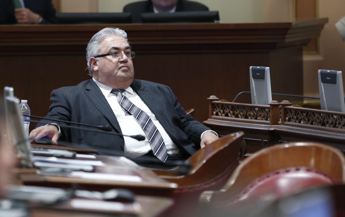 State Sen. Ronald S. Calderon (D-Montebello) sits at his desk in the Capitol before his indictment last year on corruption charges.