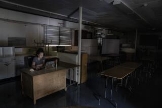 NORTHRIDGE, CA - AUGUST 18: Special education teacher Fatima Gutierrez prepares for incoming online students in her classroom with the air conditioning on and the lights off in 108 degree weather outside at Oliver Wendell Holmes Middle School Tuesday, Aug. 18, 2020 in Northridge, CA. Brian van der Brug / Los Angeles Times)