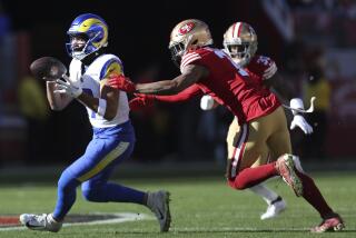 Rams wide receiver Puka Nacua, left, catches a pass in front of 49ers cornerback Charvarius Ward.