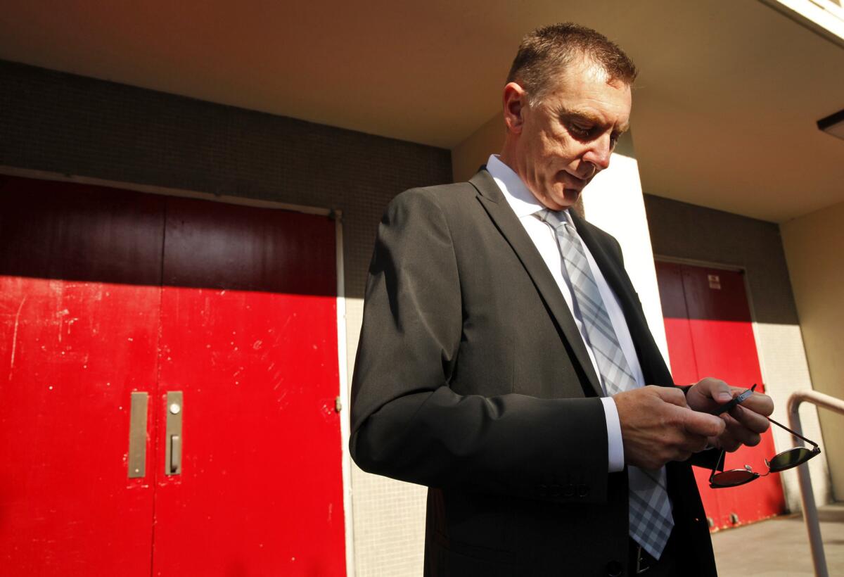 Los Angeles Unified School District Supt. John E. Deasy, texting before making his annual address to administrators last year. His district is one of many fighting a new financial proposal from Gov. Jerry Brown that would limit budget reserve funds.