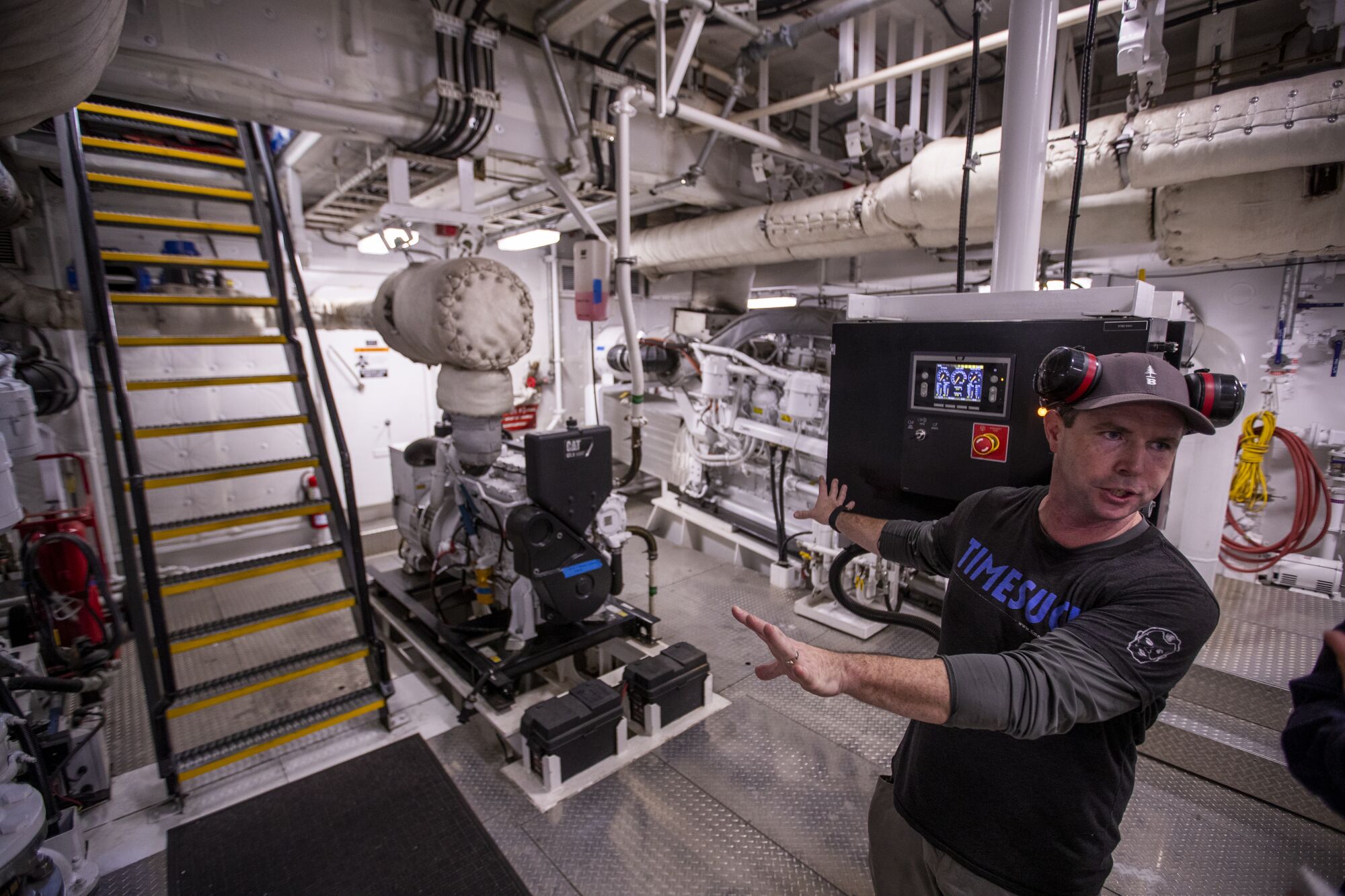 Deckhand and engineer Max Cota examines the engine room of the Delta Teresa. 