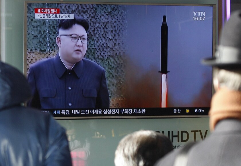 South Koreans watch a television news broadcast at a station in Seoul after North Korea conducted a ballistic missile test in February 2017.