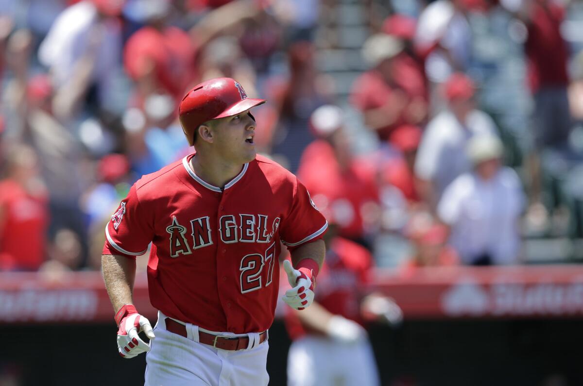 The Angels' Mike Trout watches the flight of his home run during a game against the Seattle Mariners on Sunday.