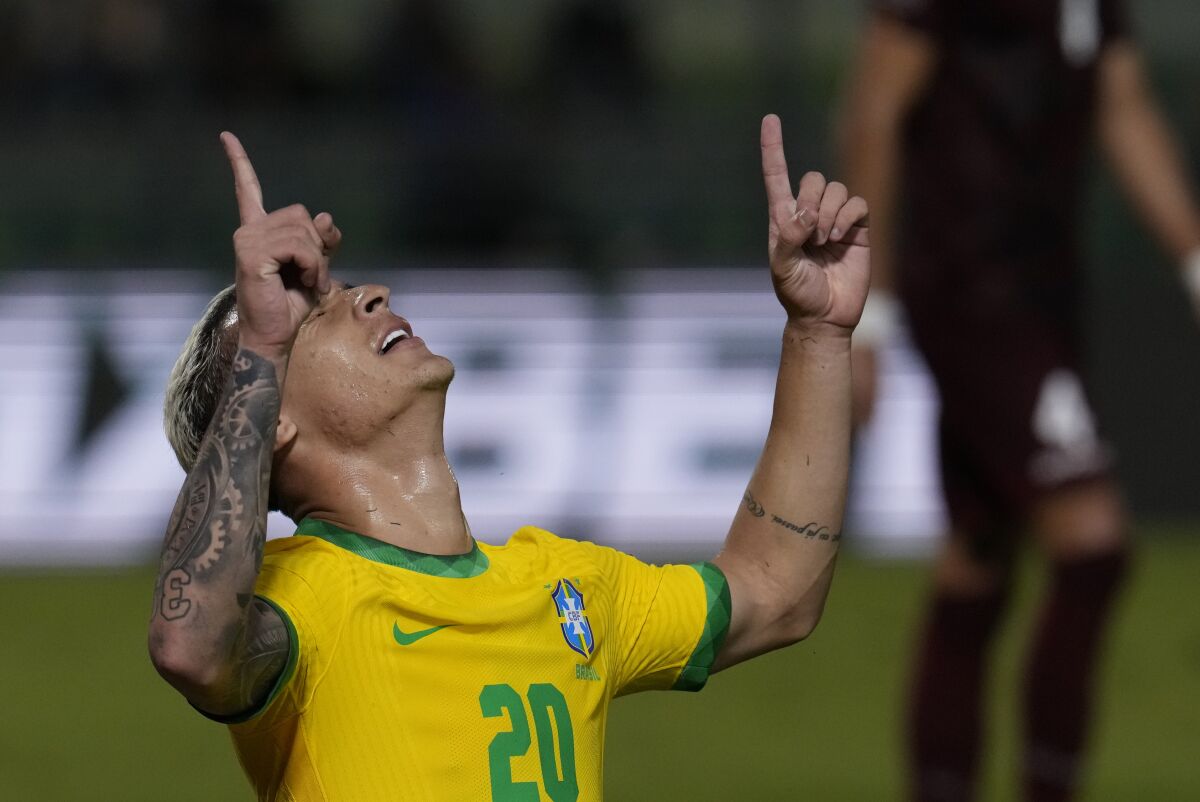 Brazil's Antony celebrates scoring his side's third goal against Venezuela during a qualifying soccer match for the FIFA World Cup Qatar 2022 at UCV Olympic Stadium in Caracas, Venezuela, Thursday, Oct.7, 2021. Brazil won 3-1. (AP Photo/Ariana Cubillos)