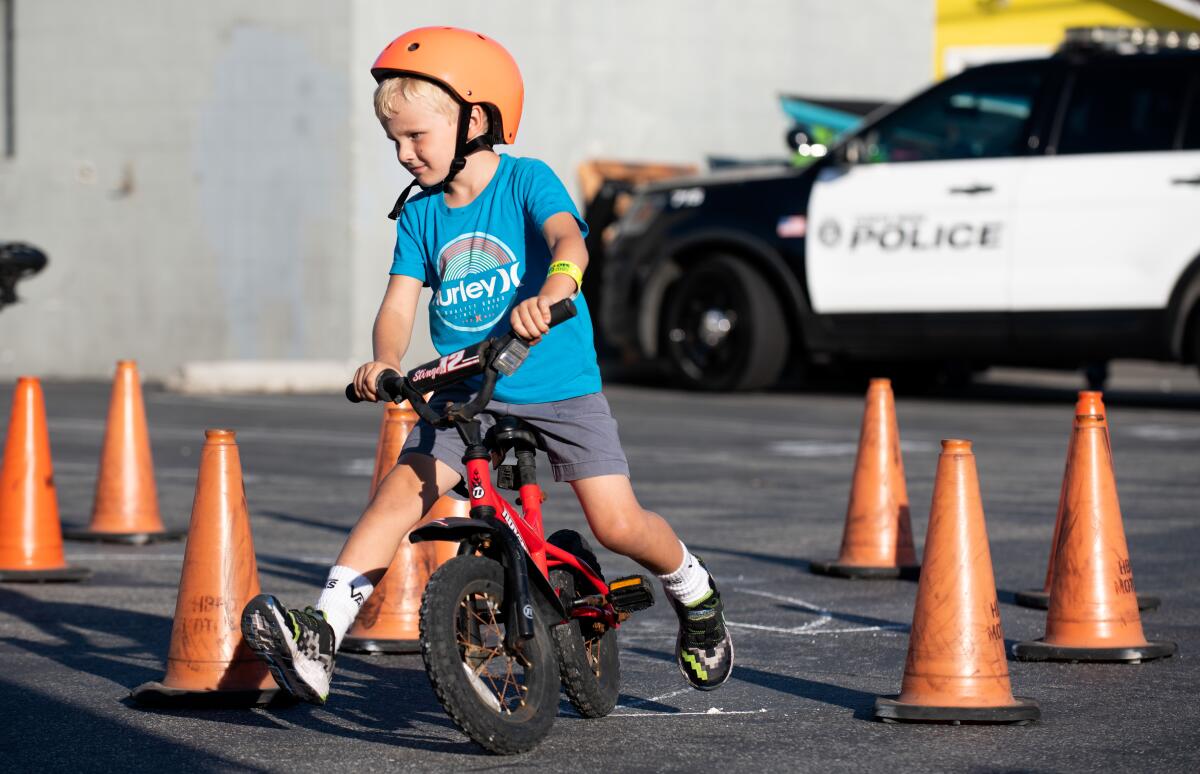 Bentley Williams races through an obstacle course at the Huntington Beach Police Department's Bike Rodeo Tuesday.