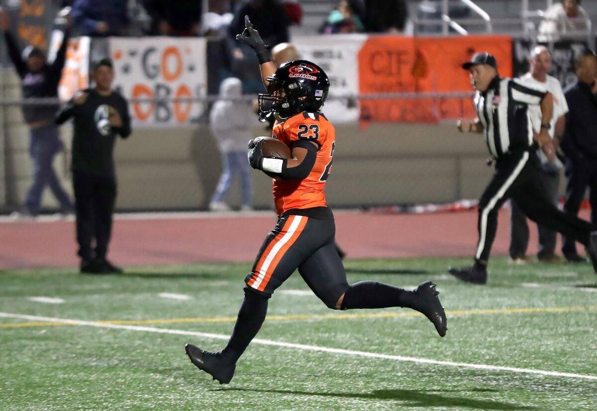 Pedro Hernandez of Los Amigos jogs in for a touchdown during a football playoff game against Walnut on Friday.