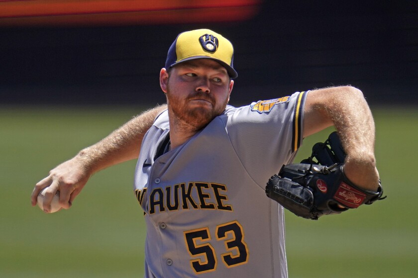 Milwaukee Brewers starting pitcher Brandon Woodruff delivers during the first inning of a baseball game against the Pittsburgh Pirates in Pittsburgh, Sunday, July 3, 2022. (AP Photo/Gene J. Puskar)