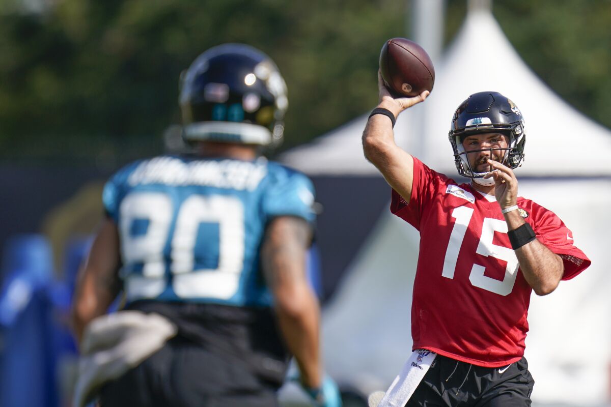 Jacksonville Jaguars quarterback Gardner Minshew (15) throws a pass to tight end James O'Shaughnessy (80) during NFL football practice, Friday, Aug. 6, 2021, in Jacksonville, Fla. (AP Photo/John Raoux)